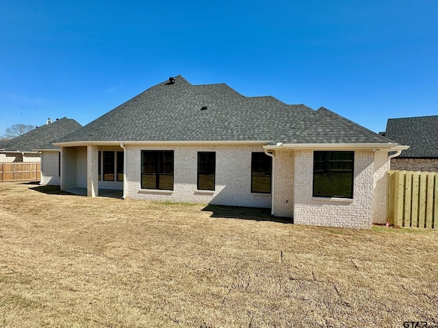 rear view of house featuring a yard and a patio