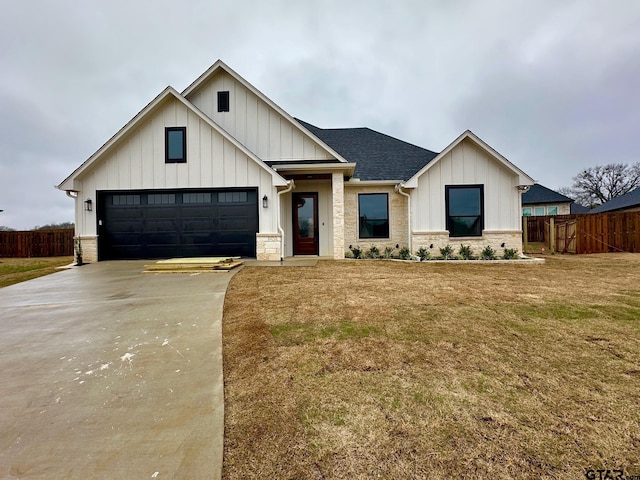 modern farmhouse style home featuring a garage and a front yard