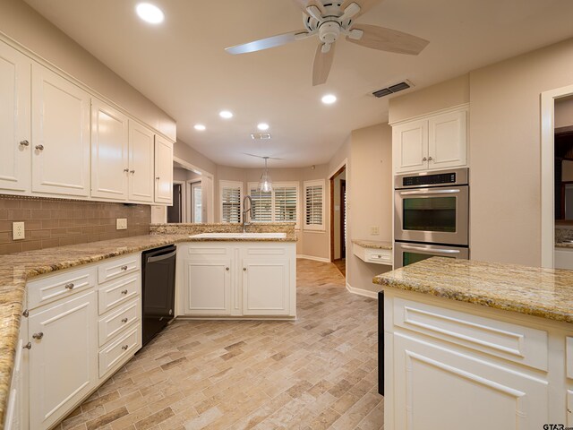 kitchen featuring ceiling fan, sink, hanging light fixtures, black dishwasher, and white cabinets