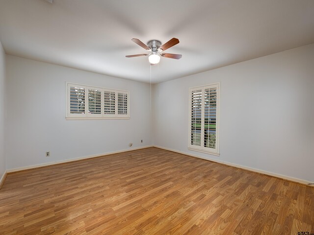 unfurnished room featuring ceiling fan and light wood-type flooring