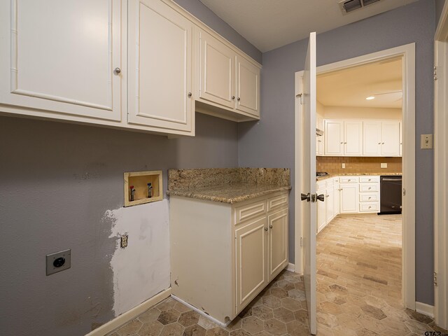 laundry room featuring washer hookup, hookup for an electric dryer, and cabinets