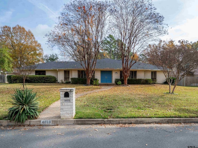 ranch-style home with a front lawn