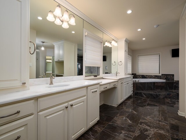 bathroom with vanity, a bath, and a notable chandelier