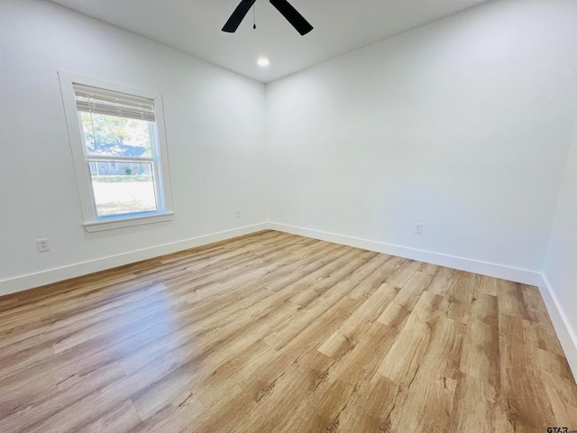 spare room with light hardwood / wood-style flooring and ceiling fan