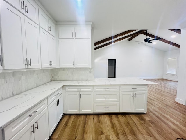 kitchen with light wood-type flooring, ceiling fan, vaulted ceiling with beams, and white cabinets