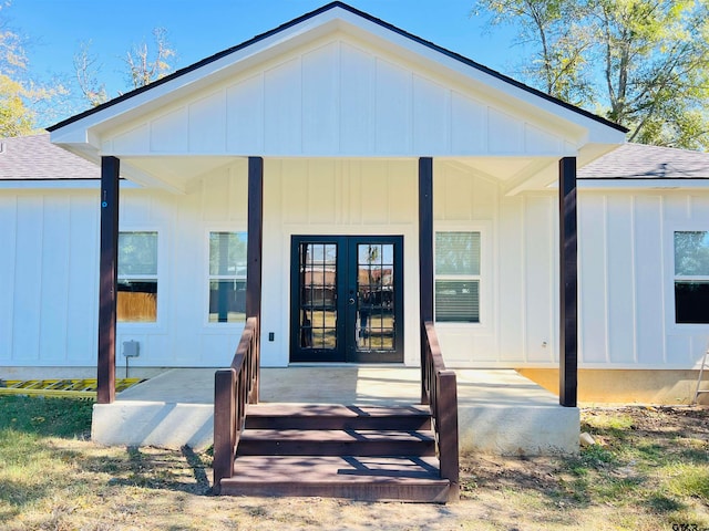 property entrance featuring covered porch and french doors