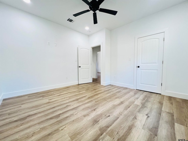 spare room featuring light wood-type flooring and ceiling fan