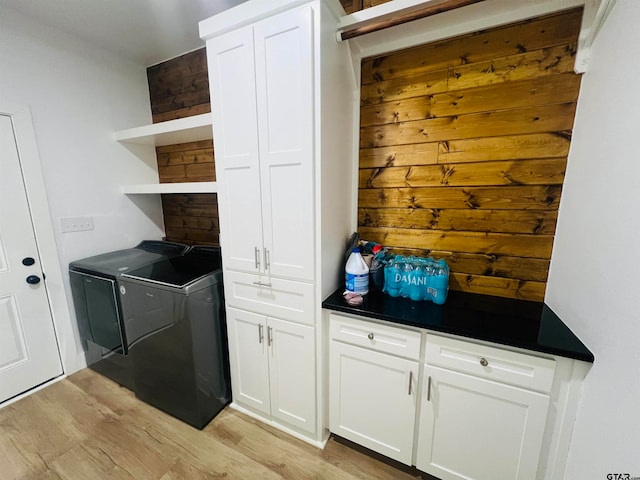 washroom with separate washer and dryer and light hardwood / wood-style flooring