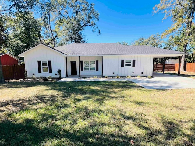 view of front facade with a front yard and a carport