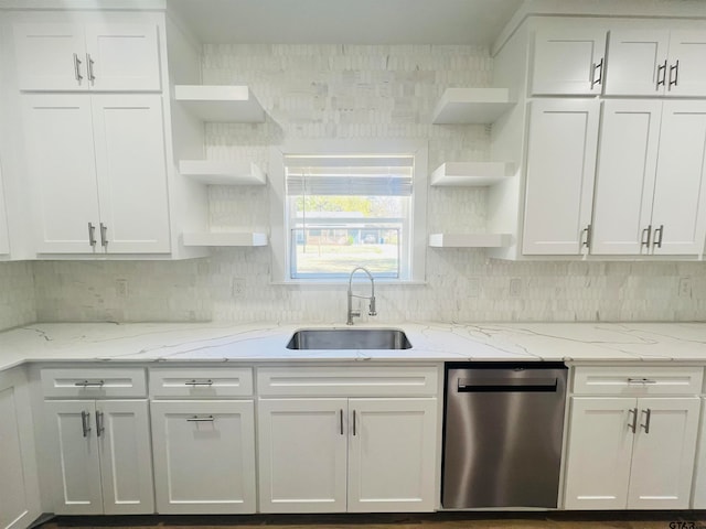 kitchen featuring dishwasher, white cabinets, sink, and light stone countertops