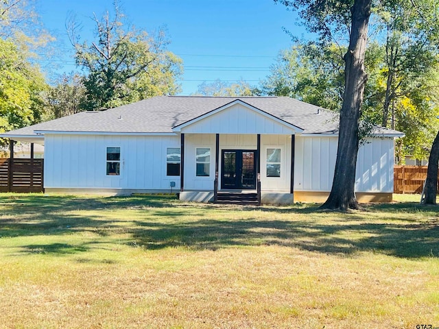 rear view of property with a yard