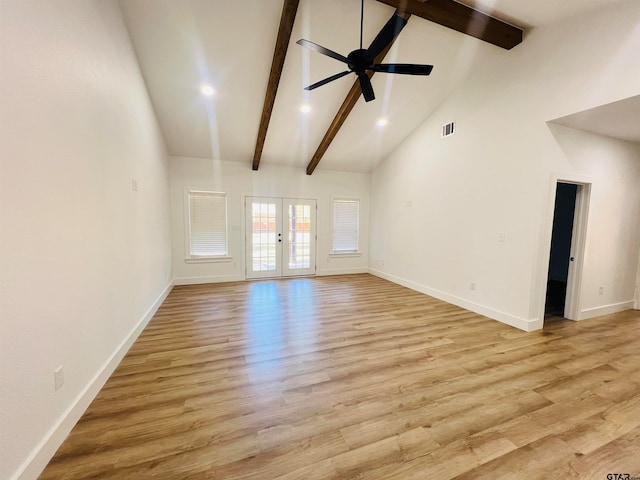 unfurnished living room with french doors, high vaulted ceiling, light hardwood / wood-style floors, and beam ceiling