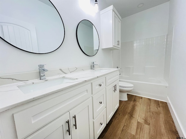 full bathroom featuring toilet, vanity, hardwood / wood-style floors, and shower / washtub combination