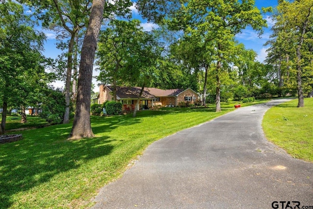 23324 Bay Side Dr, Bullard, TX 75757 - ranch-style home featuring a front lawn, driveway, and view of wooded area