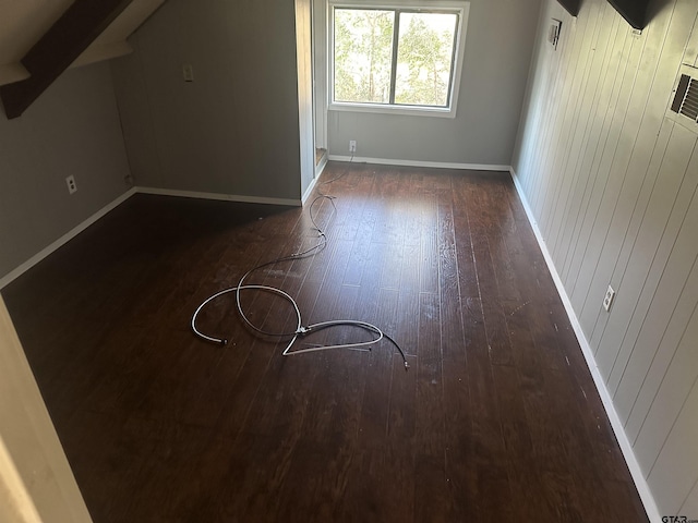 additional living space with dark hardwood / wood-style flooring