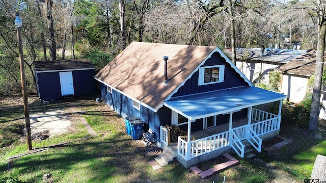 view of front of house featuring a shed and a porch