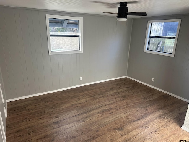 empty room with ceiling fan and dark wood-type flooring