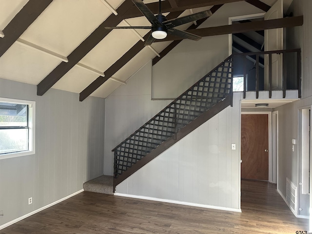 stairway with vaulted ceiling with beams, ceiling fan, and hardwood / wood-style flooring