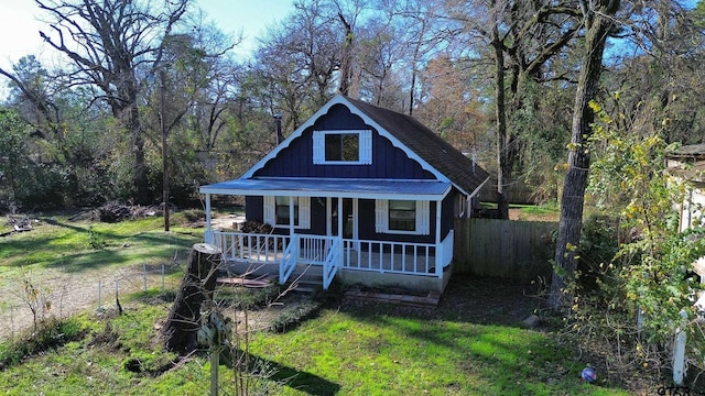 bungalow-style home with covered porch and a front yard