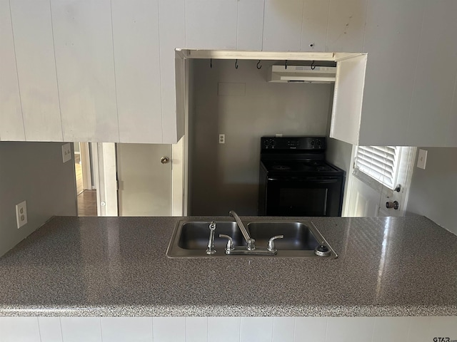 kitchen with white cabinetry, sink, and black range with electric cooktop