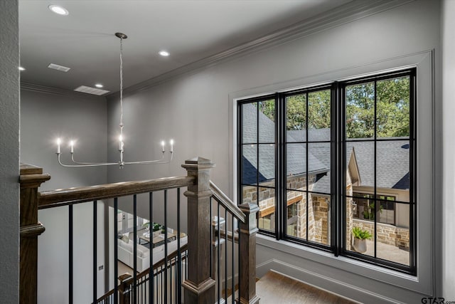 hallway with ornamental molding and hardwood / wood-style flooring