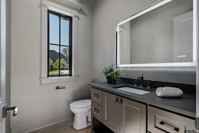 bathroom with plenty of natural light, toilet, and vanity