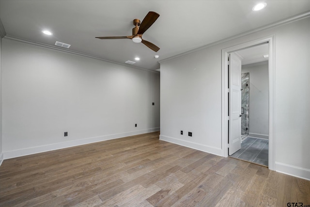 empty room featuring ceiling fan, light wood-type flooring, and ornamental molding