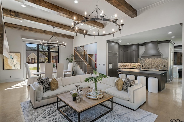 living room with sink, beamed ceiling, and an inviting chandelier