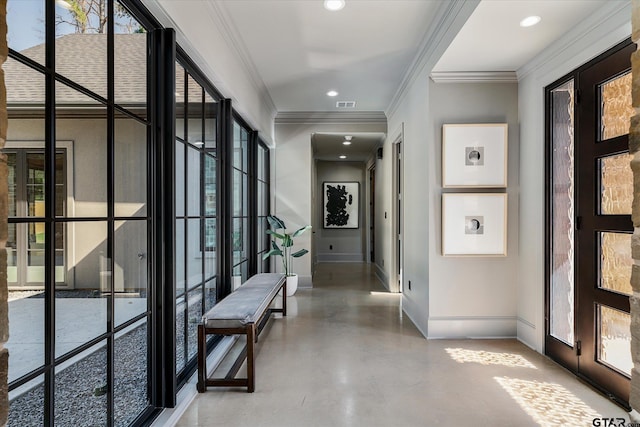 corridor featuring concrete flooring, ornamental molding, and french doors