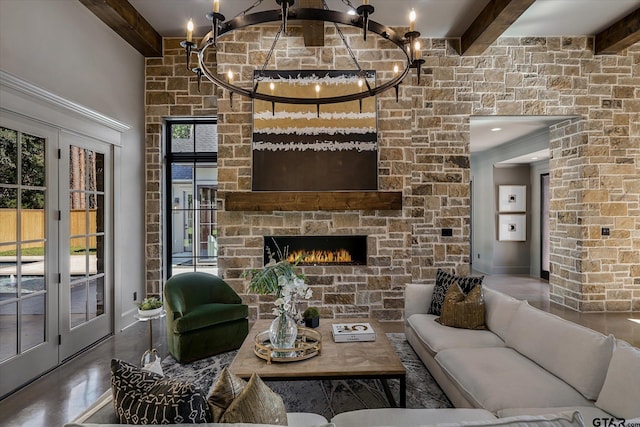 living room featuring a fireplace, concrete floors, beam ceiling, and a chandelier