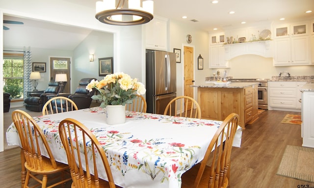 dining space with recessed lighting, dark wood-style floors, and vaulted ceiling