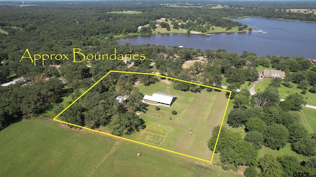 aerial view featuring a forest view and a water view
