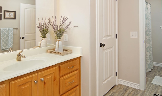 bathroom featuring hardwood / wood-style flooring and vanity