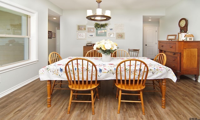 dining space featuring baseboards and wood finished floors