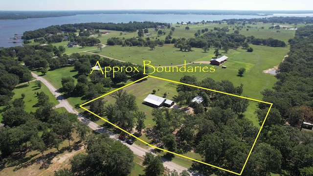 birds eye view of property with a water view and a rural view
