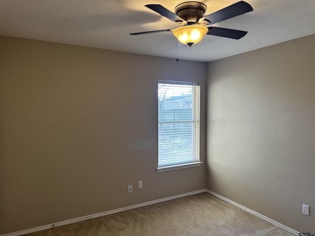 carpeted empty room featuring ceiling fan