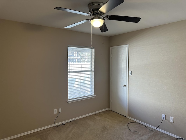 carpeted empty room featuring ceiling fan