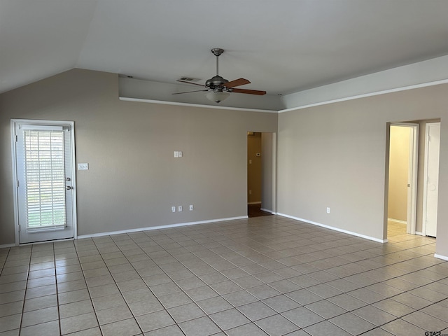 tiled spare room with ceiling fan and vaulted ceiling