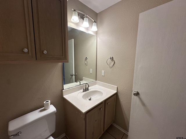 bathroom with vanity, toilet, and tile patterned flooring