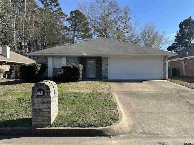 single story home with a garage, a front lawn, and central AC unit