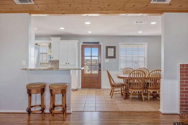 dining room featuring a healthy amount of sunlight and light wood-type flooring