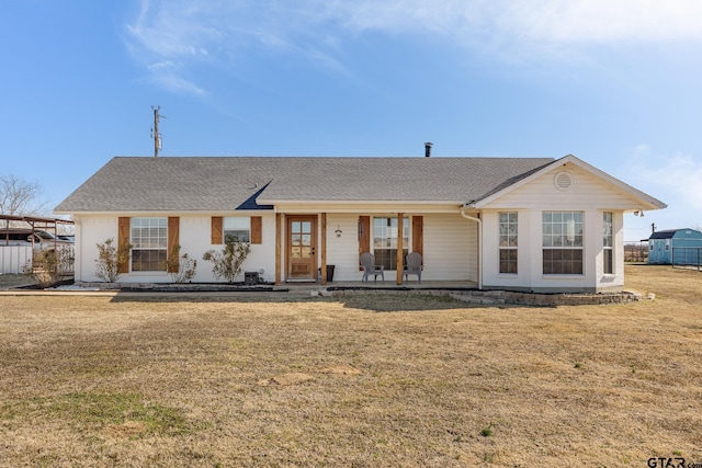 single story home featuring covered porch and a front lawn