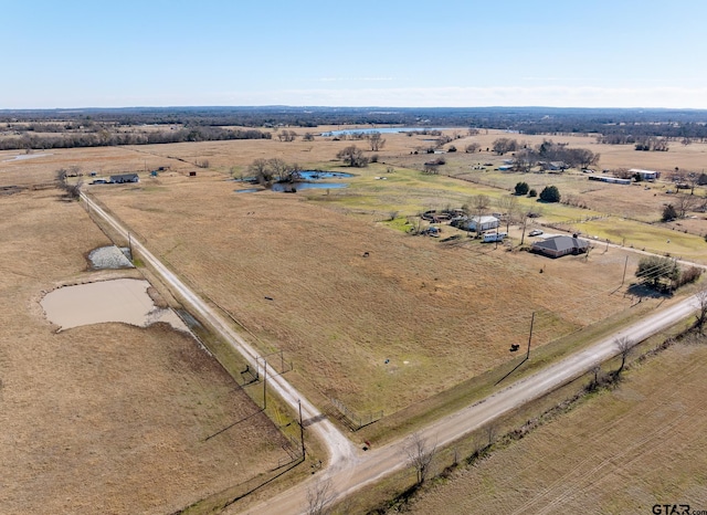 birds eye view of property with a rural view