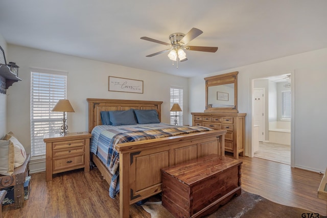 bedroom with ensuite bathroom, dark hardwood / wood-style flooring, and ceiling fan