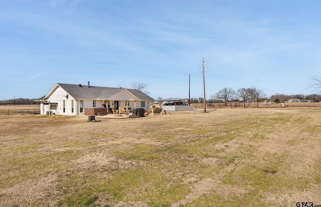 view of yard with a hot tub, a rural view, and a patio area