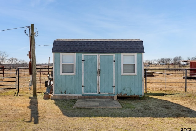 view of outbuilding featuring a yard and a rural view