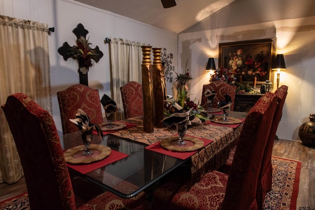 dining room with vaulted ceiling, hardwood / wood-style floors, and ceiling fan