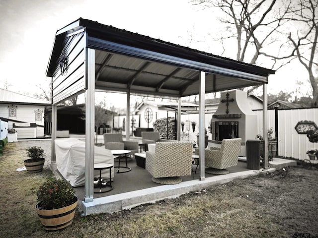 view of patio featuring an outdoor living space with a fireplace