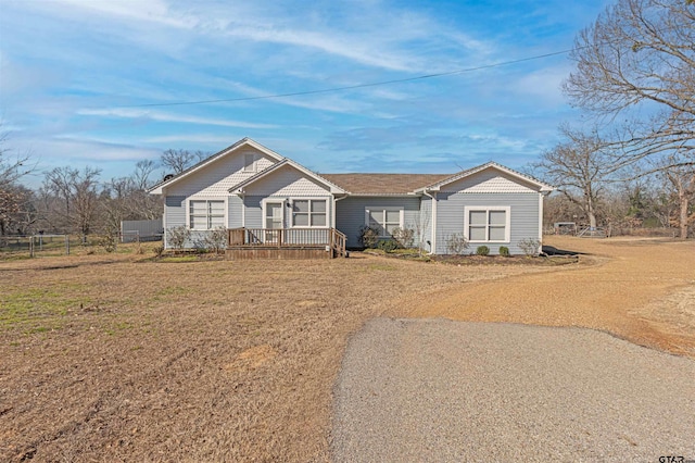 view of front of house with a front lawn, fence, and a deck