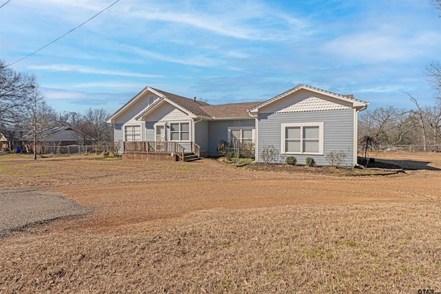 view of front facade with a front yard and a wooden deck